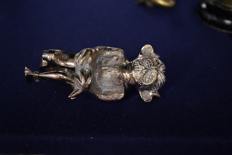 Seven chrome, brass and aluminium car mascots, etc. including an unusual and comical aluminium car mascot in the form of a squirrel holding a nut, together with a standing bear, an Art Deco winged head, a ram, a running